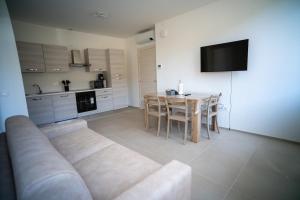 un soggiorno con tavolo e divano e una cucina di 13 Nevoso Palace a Milano Altre 15 foto