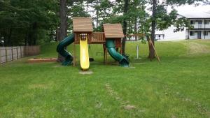a playground with a slide in a yard at Seabrook Inn in Seabrook