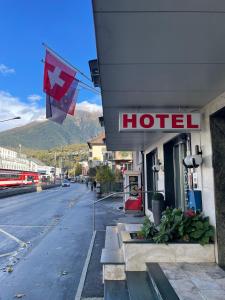 a hotel with a canadian flag on the side of a street at Hotel Europe Brig in Brig
