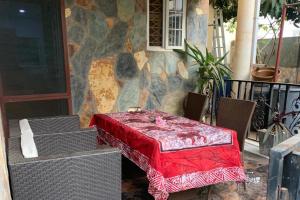 a table with a red table cloth on a patio at 1Bed Apartment - Parking Wifi Balcony Bbq in Tema