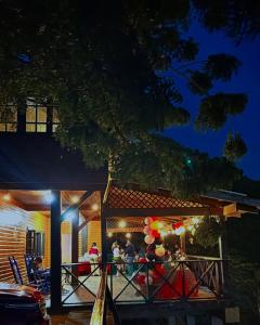 um grupo de pessoas em uma varanda à noite em Romantic Refuge under the Stars, Villa BellaVista em Tamboril mais 26 fotografias