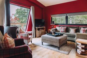 a living room with red walls and couches at Isabella in Richmond