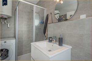 a bathroom with a sink and a washing machine at Ferienwohnung Inselzauber in Ostseebad Koserow +34 photos