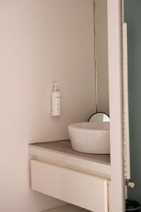 a bathroom with a sink and a mirror at Hôtel Ar Iniz in Saint Malo
