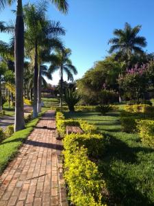 a path in a park with palm trees at Hotel Fazenda Moinho in Esmeraldas