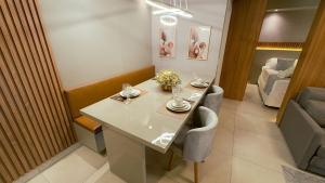 a dining room with a table and two chairs at Apartamento com aconchego e modernidade Apogeo in Ribeirão Preto +43 photos