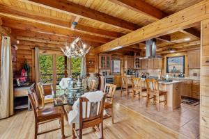 a dining room and kitchen with a table and chairs at Ponderosa 1887 in Vilas