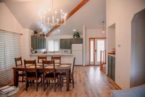 a kitchen and dining room with a table and chairs at Sage & Pine Modern Townhome in Klamath Falls