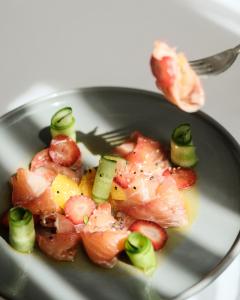a plate of food with shrimp and vegetables at Palace Hotel & SPA in Durrës