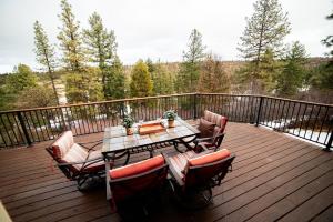 a patio with a table and chairs on a deck at Sage & Pine Modern Townhome in Klamath Falls