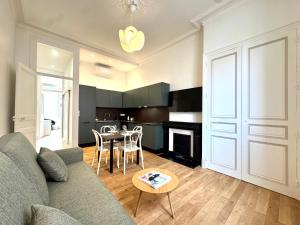 a living room with a couch and a table at Le Porte de France, 6 pers, 300 m gare, Climatisation in Grenoble +19 photos