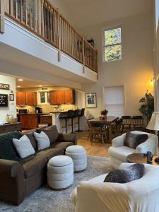 a living room with two couches and a kitchen at The Lookout at Loon Lake in Plymouth