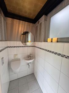 a bathroom with a sink and a mirror at Ruhe und Living in Unterraderach +13 photos