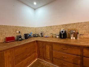 a kitchen with wooden cabinets and a counter top at The Secret Oasis Villa in Cap Malheureux