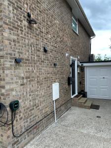a brick house with a white door and a garage at King Room in Windsor with Private Bathroom in Windsor