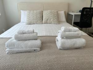 a bedroom with a bed with towels on it at King Room in Windsor with Private Bathroom in Windsor