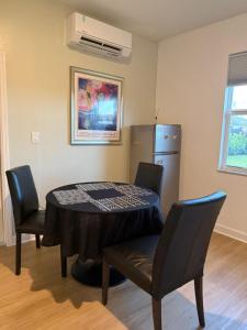 a room with a table and chairs and a refrigerator at Villa BRIGORO in Homestead