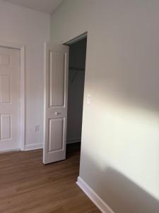 an empty room with a white door and a closet at Villa BRIGORO in Homestead