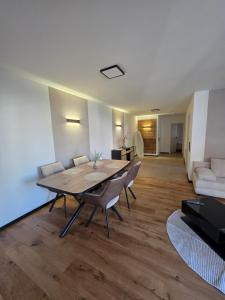 a living room with a table and chairs and a couch at Moderne 2 Zimmer Wohnung in Bad Waldsee