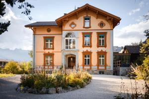 an orange house with a gambrel roof at Villa Klainguti in Pontresina