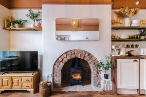 a living room with a fireplace and a tv at Rufloreo Flats 1 - central gem in Buxton