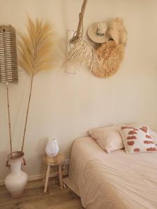 a bedroom with a bed and some plants on the wall at Bel des Prés - Cocùn - Piscine partagée in Carquefou +4 photos