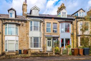 an old brick house with white windows at Rufloreo Flats 1 - central gem in Buxton