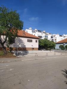 een lege straat met witte gebouwen op de achtergrond bij Apartments Lukas 5 in Zadar