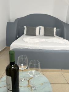a bottle of wine and two wine glasses on a table at Golden Hotel in Sauk