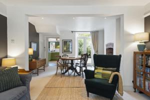 a living room with a couch and a table at Cottage in central Porlock with garden & parking in Porlock