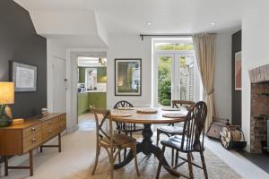 a kitchen and dining room with a table and chairs at Cottage in central Porlock with garden & parking in Porlock +14 photos
