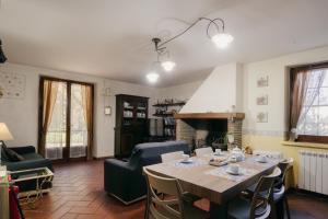 a living room with a table and a fireplace at Le Margherite in Castiglione del Lago