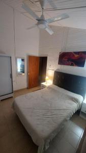 a bedroom with a bed and a ceiling fan at El Cerrito del Valle in Santa María