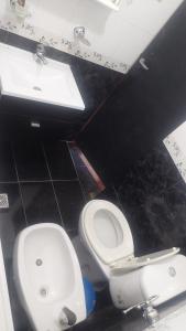 a bathroom with a toilet and a sink at El Cerrito del Valle in Santa María +14 photos