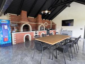 a dining room with a wooden table and chairs at Casa Pop in Petrova