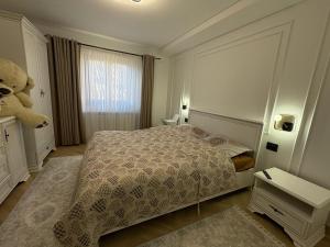 a bedroom with a bed and a teddy bear at Casa Pop in Petrova