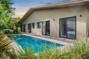 a house with a swimming pool in front of it at Casa Ola - Tropical Beachside Escape in Playa Venao +15 photos