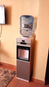 a bowl on top of a microwave with a bowl on top at Deluxe Homes, Voi in Voi