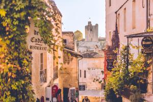 a street in an old town with a church in the background at Chambre d'hôte Ô Fil De L'isle in Savignac-sur-lʼIsle