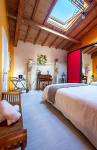 a bedroom with a large bed and a skylight at Chambre d'hôte Ô Fil De L'isle in Savignac-sur-lʼIsle