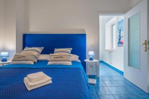 a blue bed with towels on it in a room at La Casa sul Golfo - the House on the Gulf in Massa Lubrense