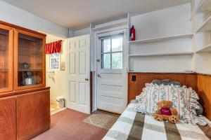a teddy bear sitting on a bed in a bedroom at 2 Mi to NYC Train Greenwich Apt with River View in Rye Brook