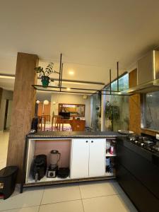 a kitchen with white cabinets and a counter top at Casa completa para cop 30 in Belém