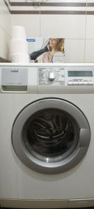 a washer and dryer with a washing machine at Cozy Apartment, Free Parking near Dajti Cable Car, Bunk'Art in Tirana