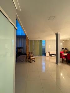 a large living room with red chairs and a table at Casa completa para cop 30 in Belém