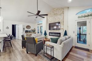 a living room with a couch and chairs and a fireplace at Hawk’s Landing at Innsbruck in Helen