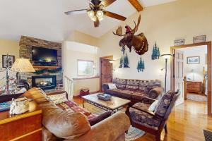 a living room with couches and a deer head on the wall at Eagle Rock in Beech Mountain