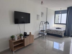 a living room with a flat screen tv on the wall at Microcentro Bebo home in Buenos Aires