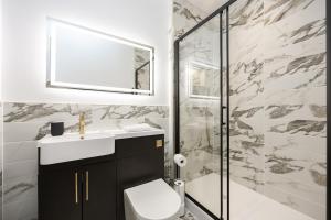 a bathroom with a sink and a shower at Luxury Flat Near Hove Station parking sleeps 4 in Moffat +34 photos