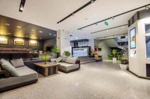 a lobby with couches and a stage in a building at Best apartment in Orbi Palace in Itʼkhvisi